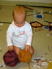 infant with yarn