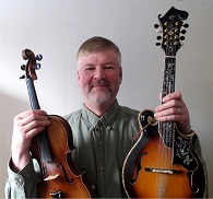 Adam Sweet 80F holding a mandolin and a violin