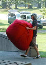 student with bean bag chair moving in