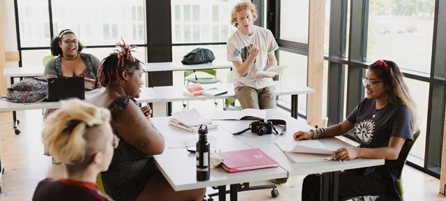 Students chat in classroom.