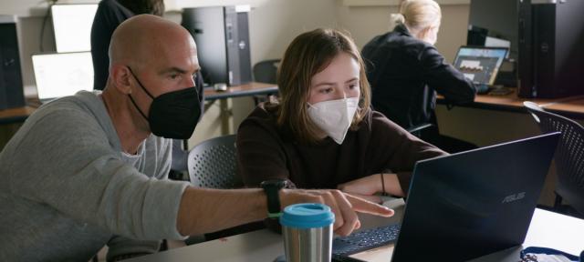 Thom Long in class teaching a student.