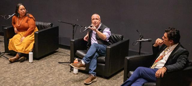 Rowen White 97F, Eric Toensmeire 90F, and Jean-Luc Pierite sitting in chairs talking