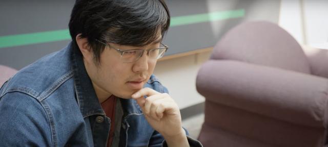 Student sits working on a laptop.