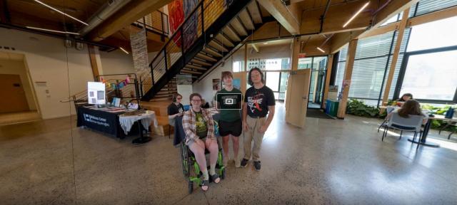 Shot from virtual tour featuring three students in the middle of the R.W. Kern Center lobby
