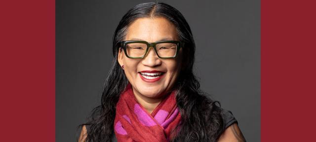 Elle Chan wearing glasses and smiling