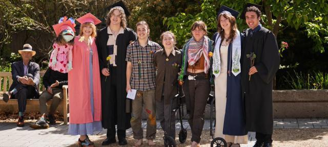 Graduates lined up and smiling
