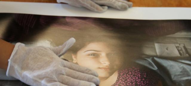 Student handling photo with gloves