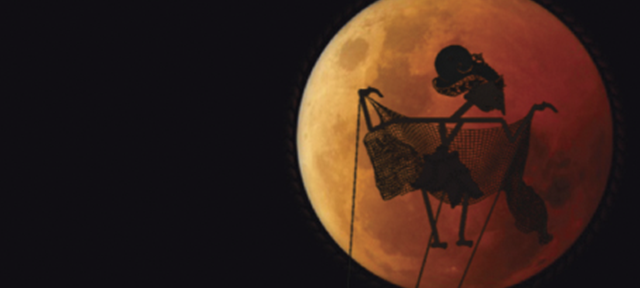 One of Antonius Wiradjada's Puppet Shows Puppet Silhouetted Against a Red Moon