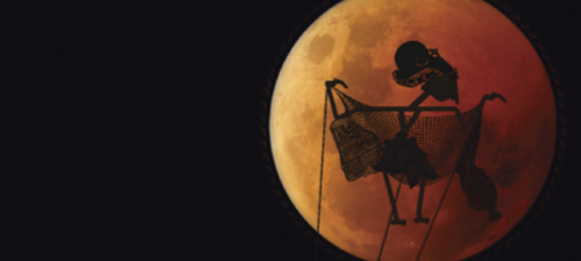 Puppet Silhouetted Against a Red Moon