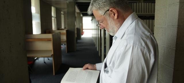 Bob McCarthy reading his Div III in the Library