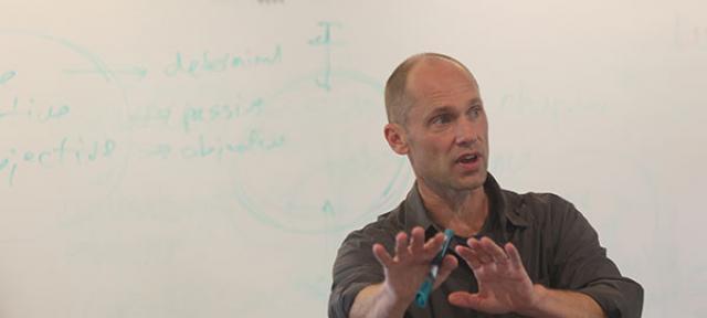 Christoph Cox in classroom in front of whiteboard