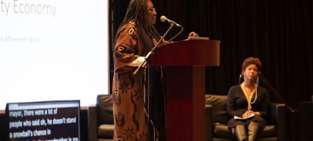 Safia Omari speaking to a crowd at the Eqbal Ahmad Symposium