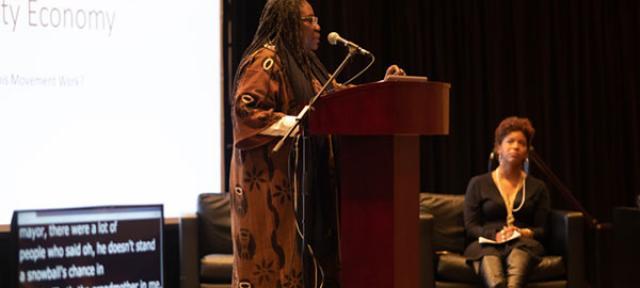 Safia Omari speaking to a crowd at the Eqbal Ahmad Symposium