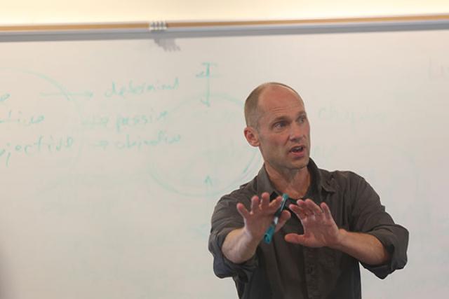 Christoph Cox in classroom in front of whiteboard
