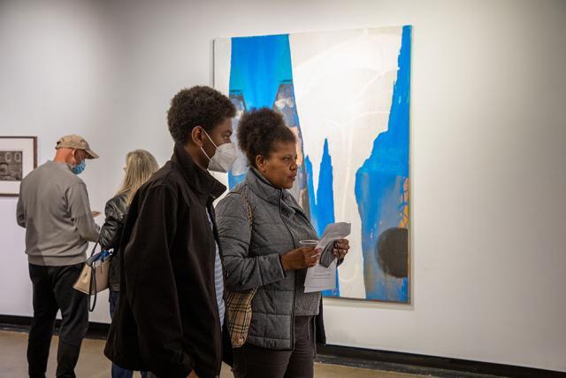 Guests look at art in the gallery