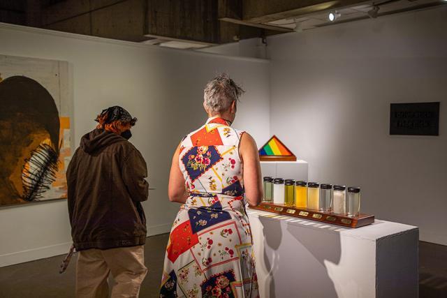 Guests look at exhibit pieces in the gallery