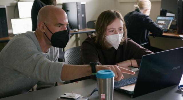 Thom Long in class teaching a student.