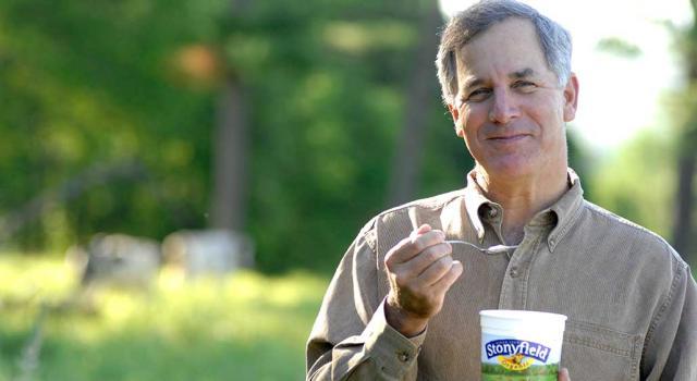 Gary Hirshberg in field with yogurt