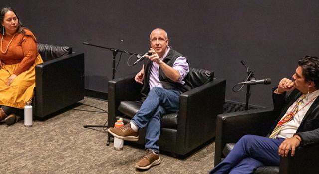 Rowen White 97F, Eric Toensmeire 90F, and Jean-Luc Pierite sitting in chairs talking