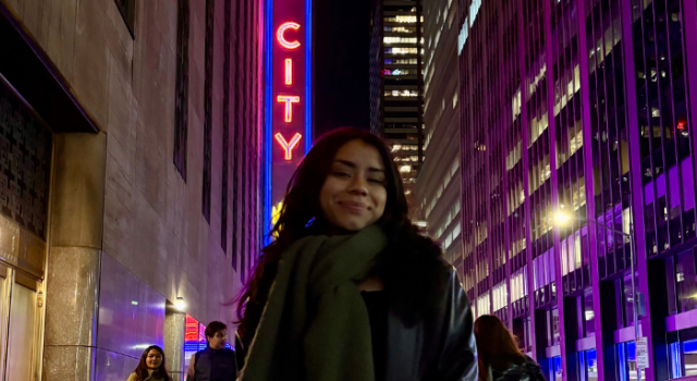 Student Jazlyn Cabrera F24 stands outside in the city.
