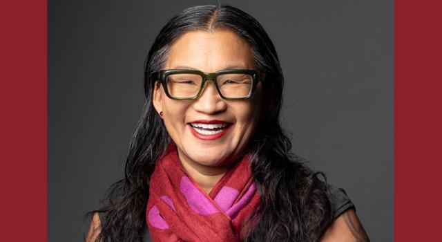 Elle Chan wearing glasses and smiling