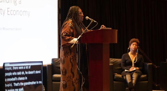 Safia Omari speaking to a crowd at the Eqbal Ahmad Symposium