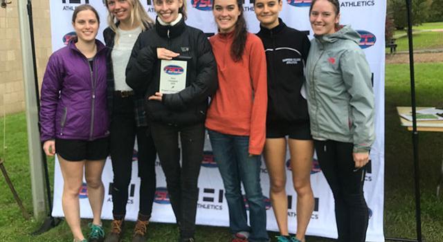 Women's Cross Country winners stand with awards