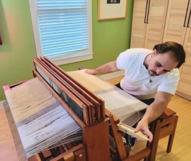 Alum Anders Zanichkowsky 04F weaving at a loom.