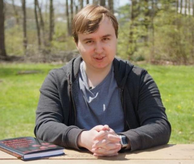 Nick Bythrow 18F sitting at a table outside.