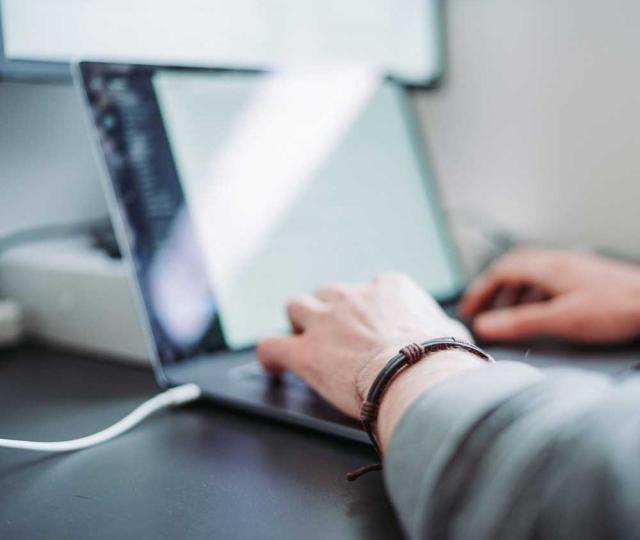 Person typing on a laptop.