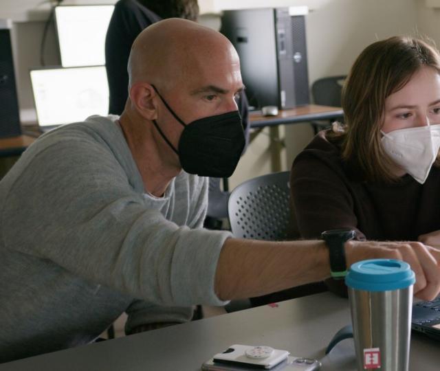 Thom Long in class teaching a student.