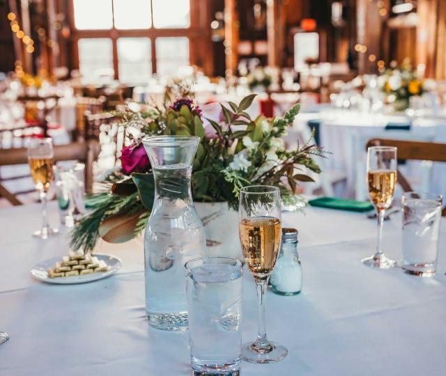 White table cloth dining table set with flowers and candles.