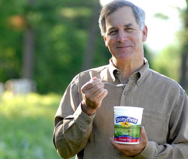 Gary Hirshberg in field with yogurt