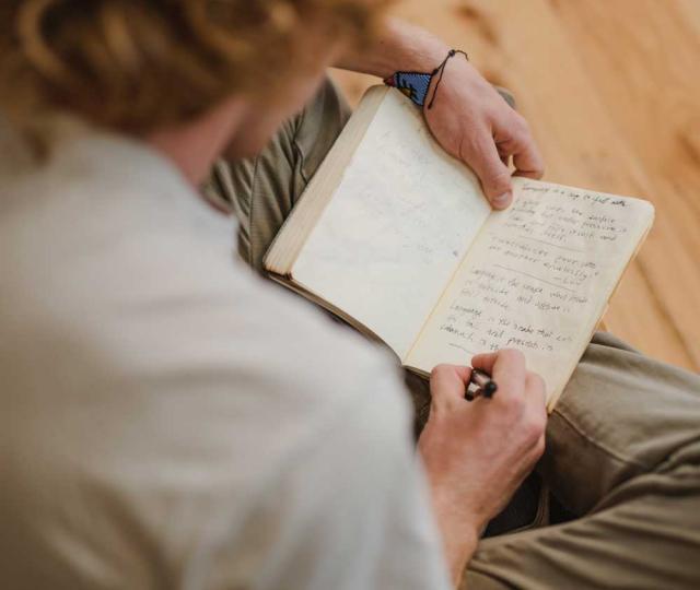 Student writing in a notebook.