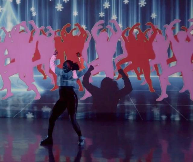 Debbie Ampong dancing with her illustrations