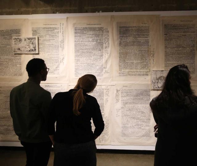 Students study an artwork by Jesse Krimes as part of a class visit during the 'Made in America' exhibition. 