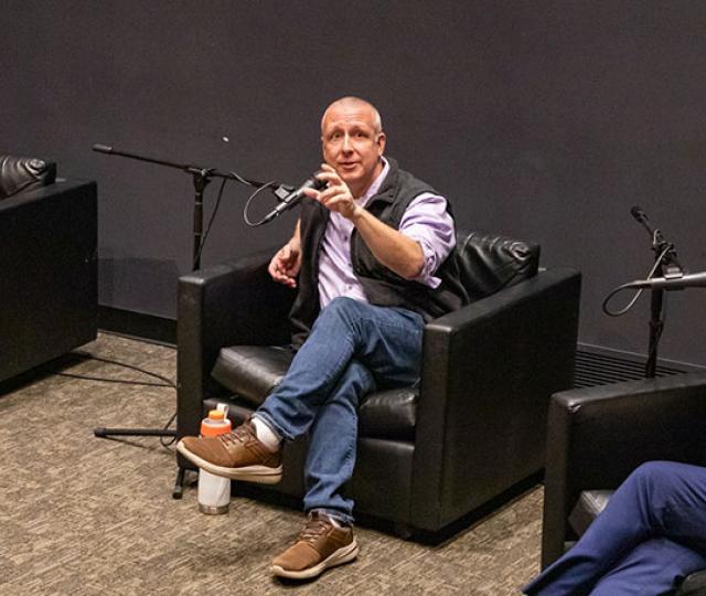 Rowen White 97F, Eric Toensmeire 90F, and Jean-Luc Pierite sitting in chairs talking