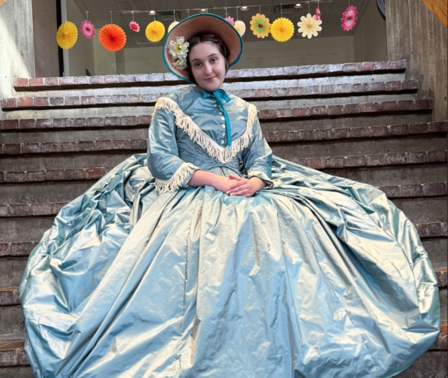 Lila Maher in a pale blue dress with voluminous skirts