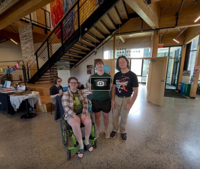 Still from virtual tour featuring three students in the center of the R.W. Kern Center lobby