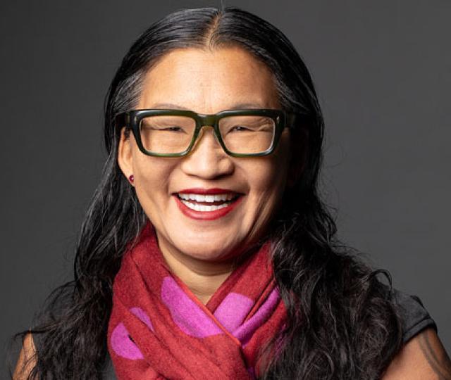 Elle Chan wearing glasses and smiling