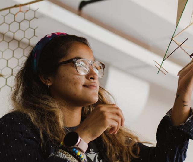 student working on a model in class