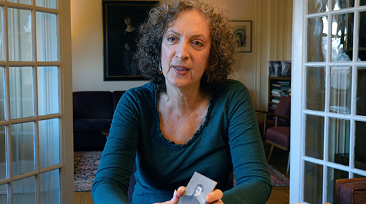 Karen Frenkel holding a photograph of her grandfather