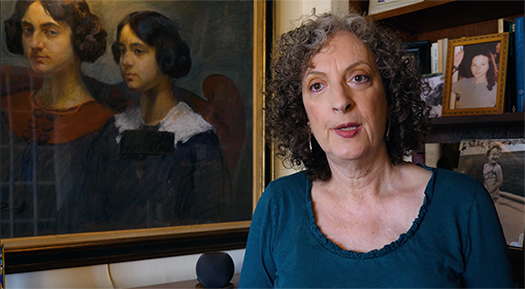 Karen Frenkel with a portrait of family members
