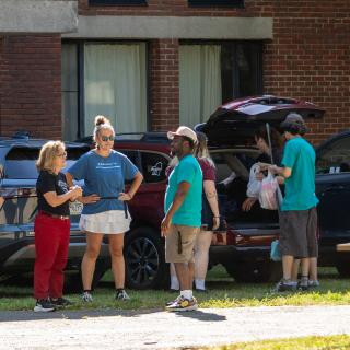 People moving items into a dorm