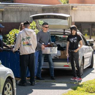 Families taking items out of cars