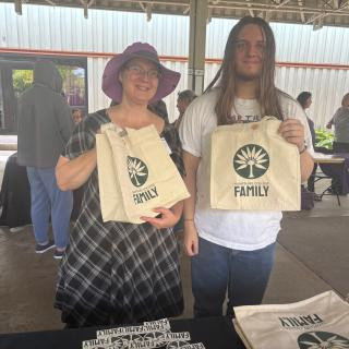 Two people hold up branded Hampshire bags