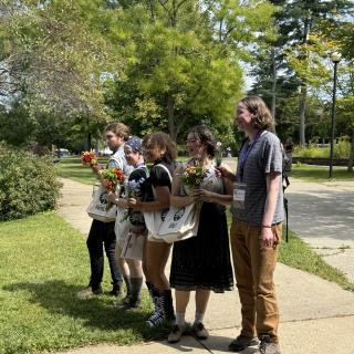 Students holding flowers