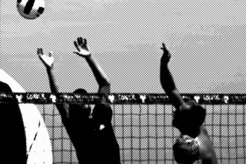 Black and white photo of people playing volleyball