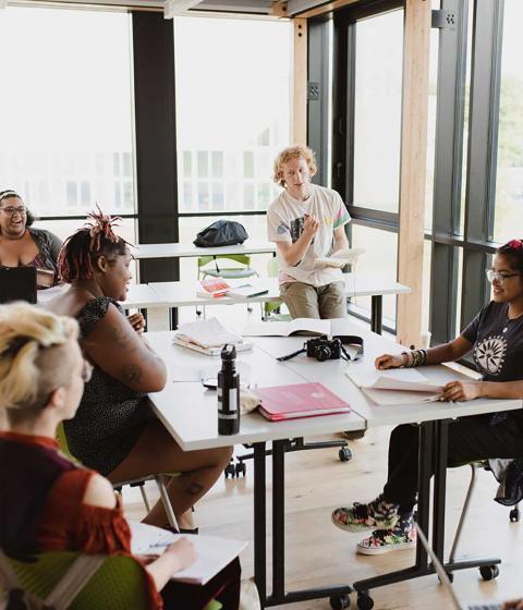 Students chat in classroom.