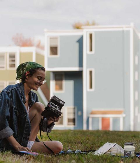 Student outside with camera.